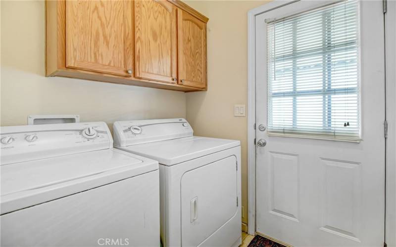 Convenient indoor laundry room with door to driveway.