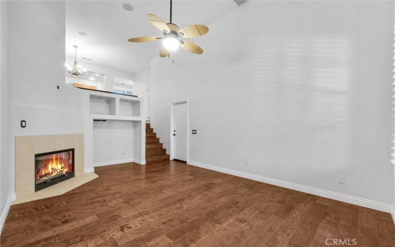 Spacious living area with high ceiling with fan