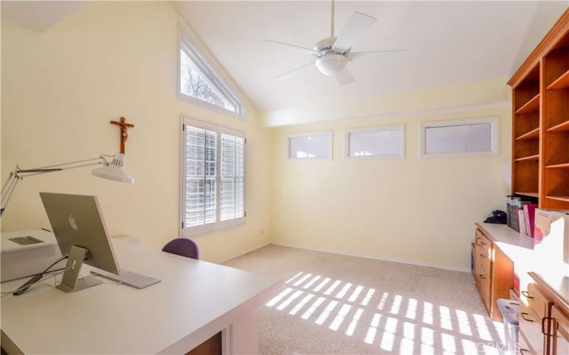 Originally a loft now enclosed as an office with built in bookcases, vaulted ceiling