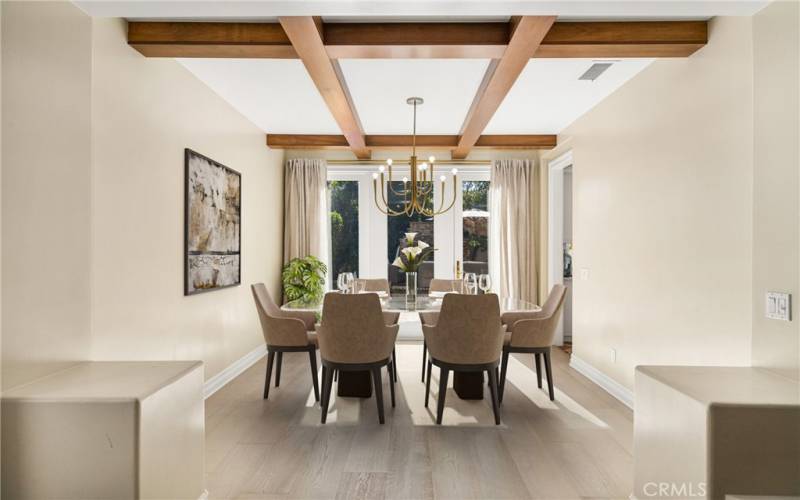 Dining room featuring modern chandelier and french doors to the backyard