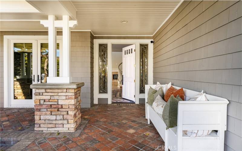 Brick porch and beautiful front door.