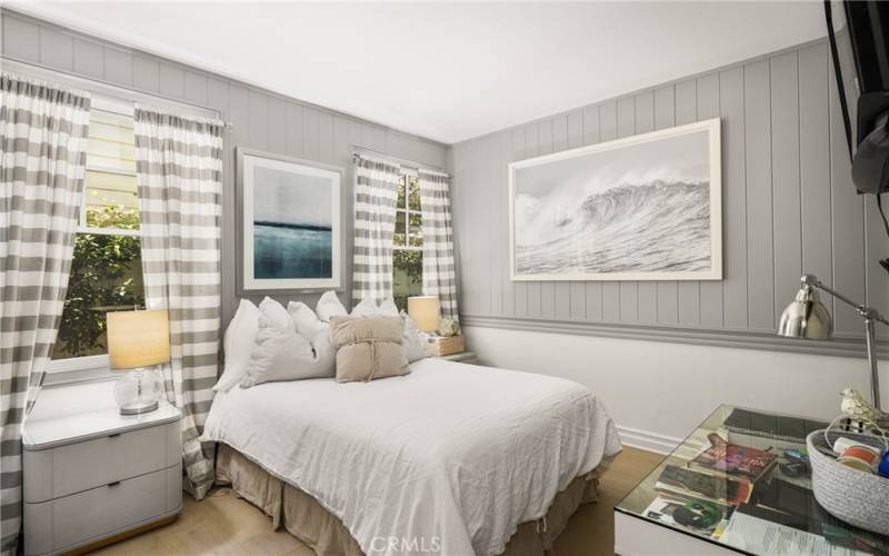 Downstairs bedroom with custom wainscoting wall treatments