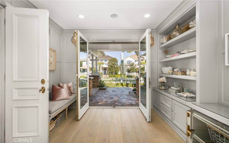 Custom built-in and french doors to front patio add to the appeal of the bonus room.