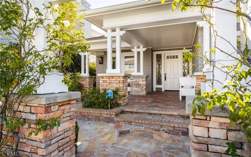 Front porch offers areas for seating and gathering.