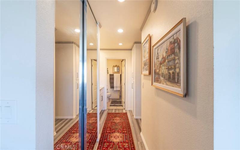 Hallway mirrored closets to the bathroom and bedroom.