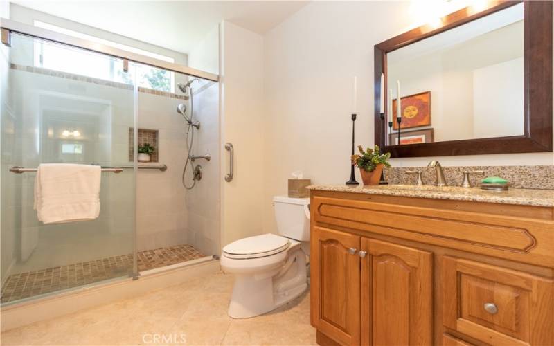 Main full bath with remodeled enclosed shower.