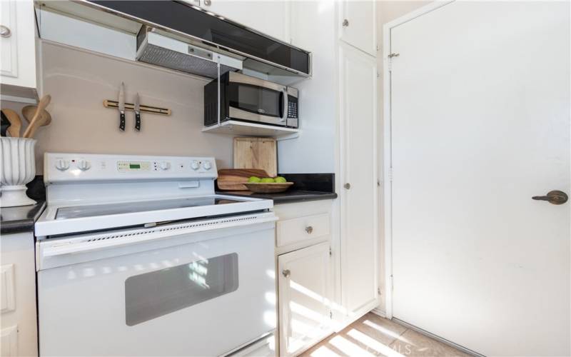 White appliances, plus garage access from the kitchen.