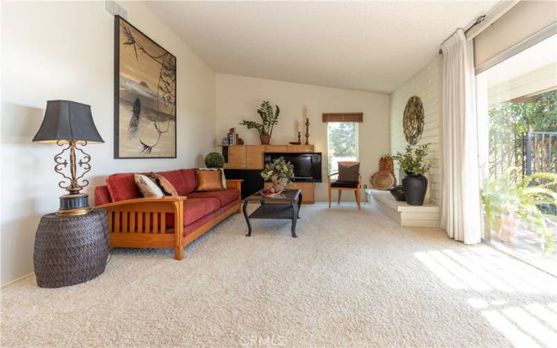 Vaulted ceiling and neutral paint and carpet.