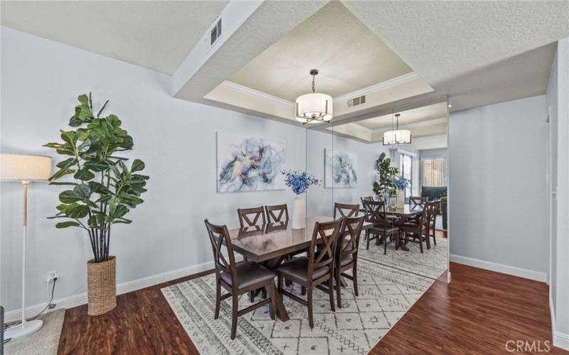 Dining area with neutral paint and updated light fixture.