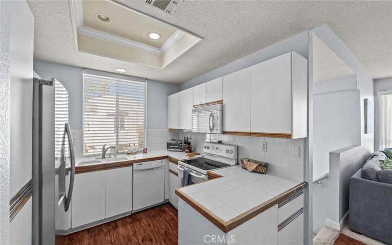 Kitchen with tile countertops and lots of cabinetry!