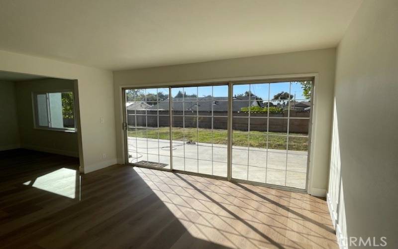 View from kitchen into dining area and backyard