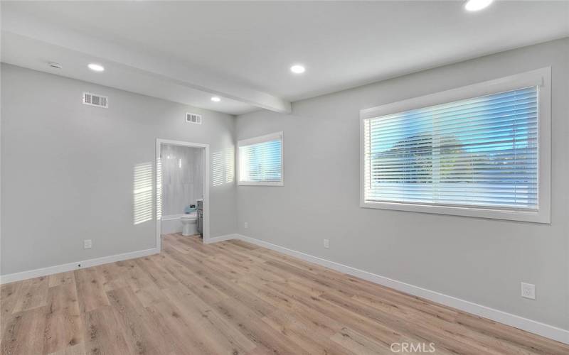 Primary Bedroom 1: New Dual Pane Windows, New Blinds, New Laminate Waterproof flooring, New Baseboards.