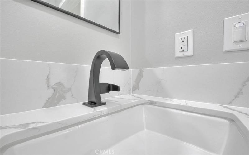 Primary Bathroom 1: New Kohler Faucet. New Quartz Counter Top and New Sink.