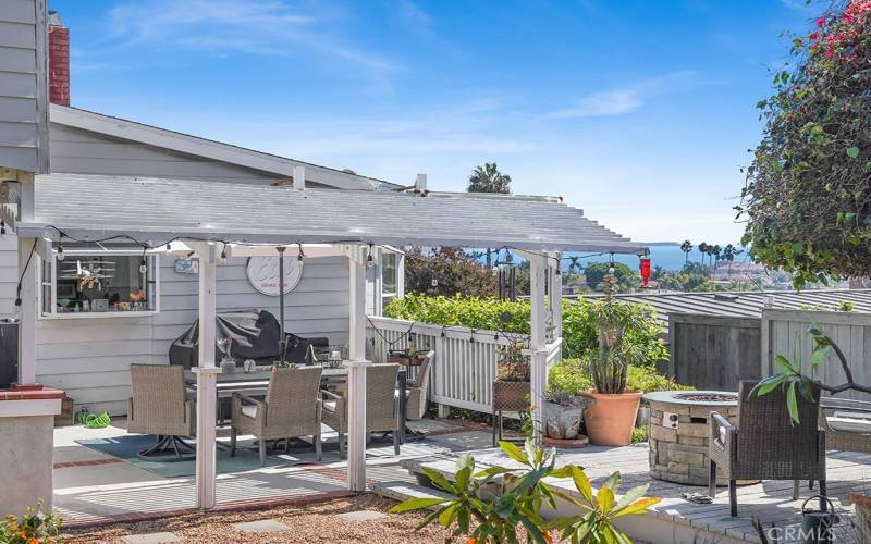 Great porch off the packyard with grill, lights, umbrella and table.