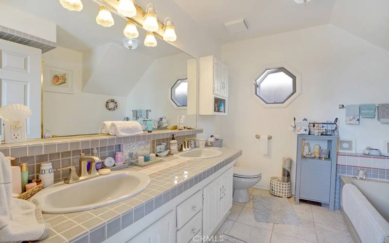 Downstairs guest bath - two sinks, tub and shower.