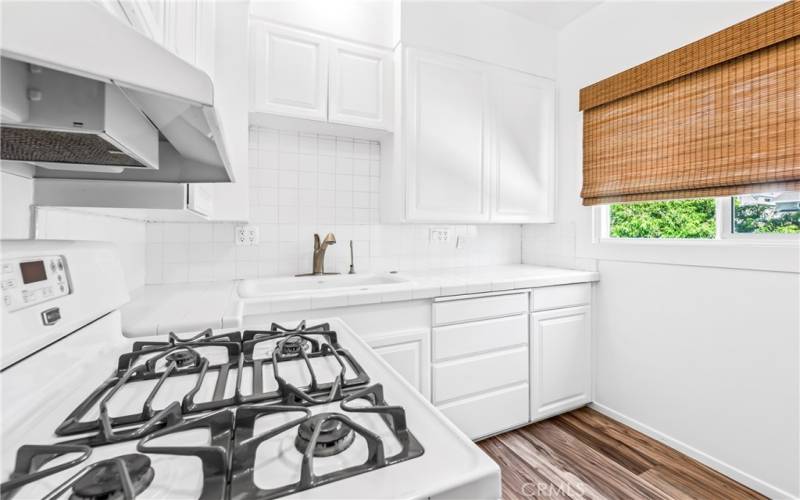 The kitchen has a door to the adorable backyard.