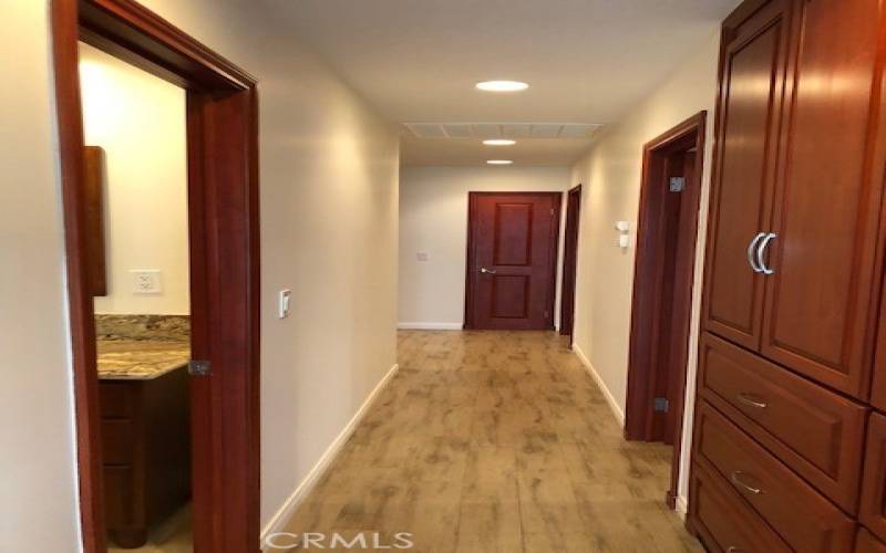 hallway leading to bedrooms, custom cabinets