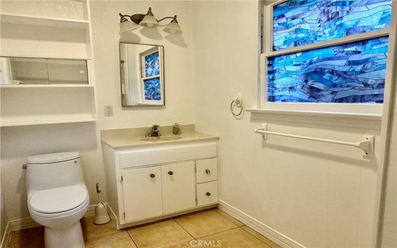 Bathroom with newer Toto toilet and full tub/shower.