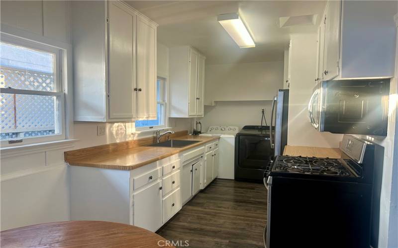 Kitchen and existing appliances including a washer and dryer.