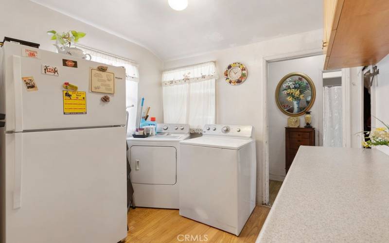 fridge and laundry space off main kitchen area