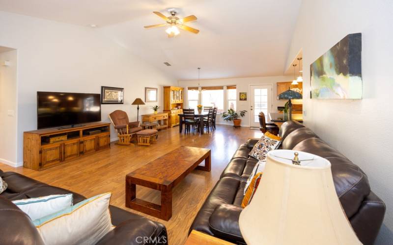 Open great room with high ceilings and beautiful floors.