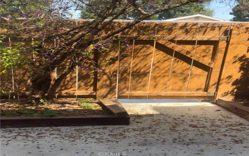 Gate from back patio directly into parking lot with designated parking spot