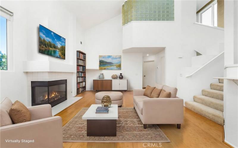 Living room with focal fireplace. (Photo is enhanced with virtual furniture!)