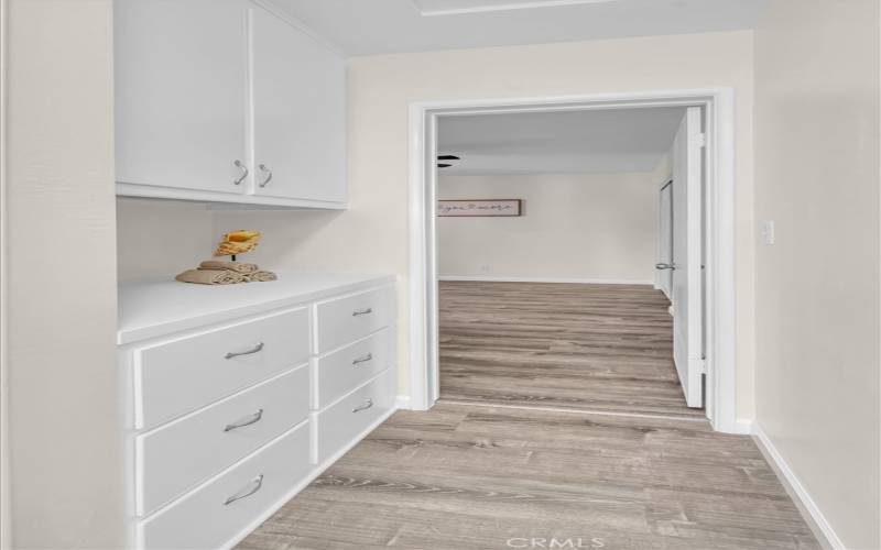 Hall from bathroom to back bedroom with built in linen storage