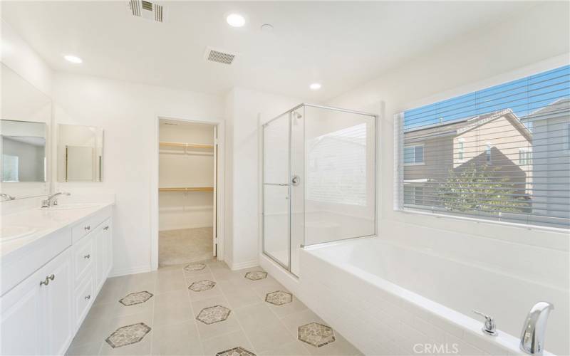 Primary bath features upgraded flooring, large soaking tub, separate shower, dual sinks, and separate toilet space w/ door. Light and bright!