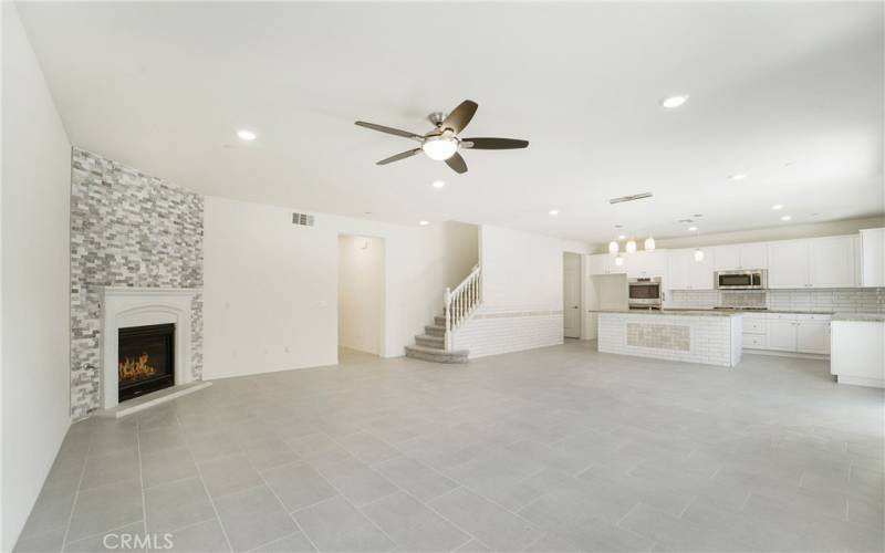 Custom tile work, a cozy fireplace, lots of light, modern, spacious great room.