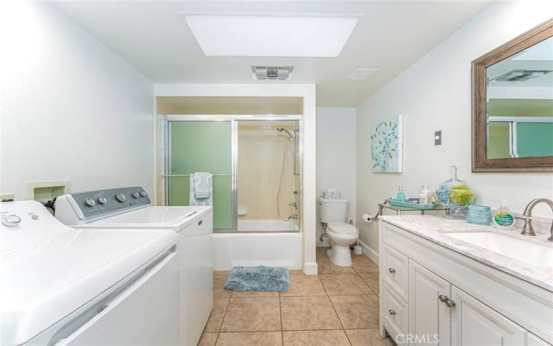 New bathroom cabinets with quartz countertops. Cast iron tub and shower combination.