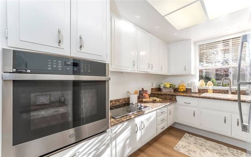 Granite countertops accent the stainless appliances.