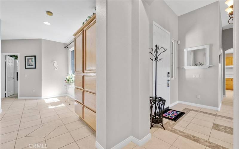 Spacious hallway with storage cabinets leading to additional 3 bedrooms.