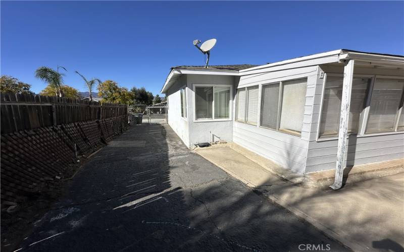 Right side of the home, you can drive a car down this side and access the detached garage.