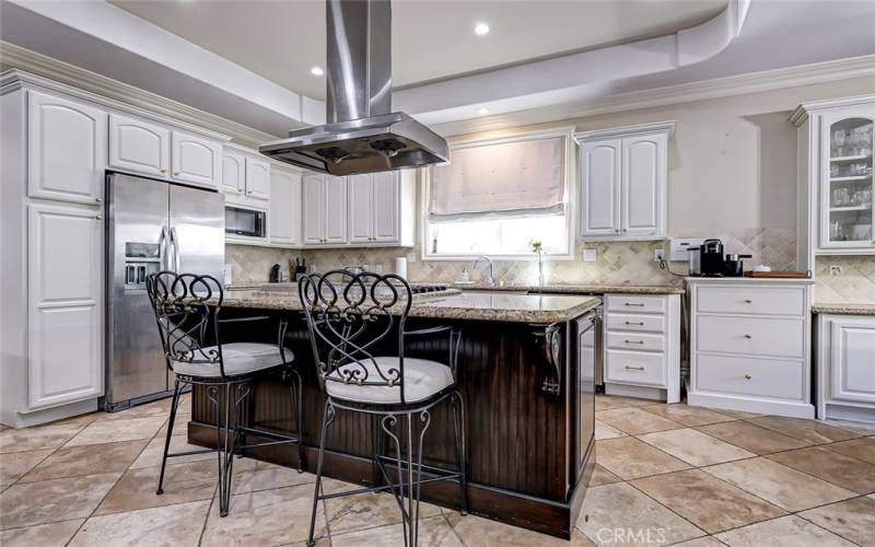 Sparkling kitchen with large center island, stainless steel appliances, and conveniently open to the family room!