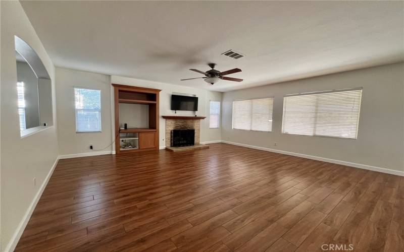 Living room with television and gas fireplace.