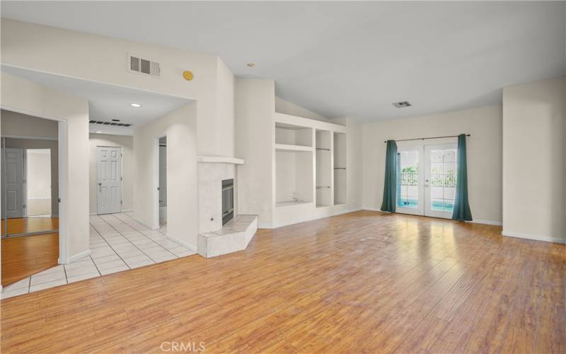 Large open floorplan. Living Room with fireplace, high ceilings, leading to back yard