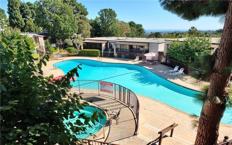 One of three beautiful pool and spa areas throughout the community with ocean views in the distance