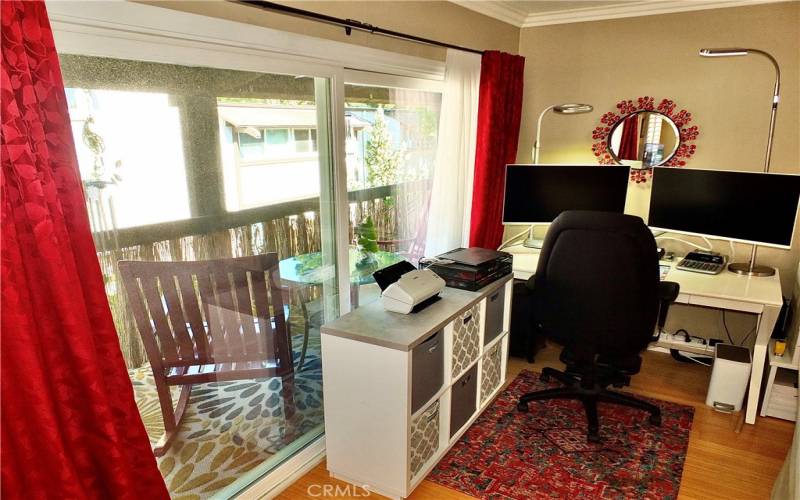 Large sliding Door to the private Balcony off Living Area looking out to the trees and grounds out front