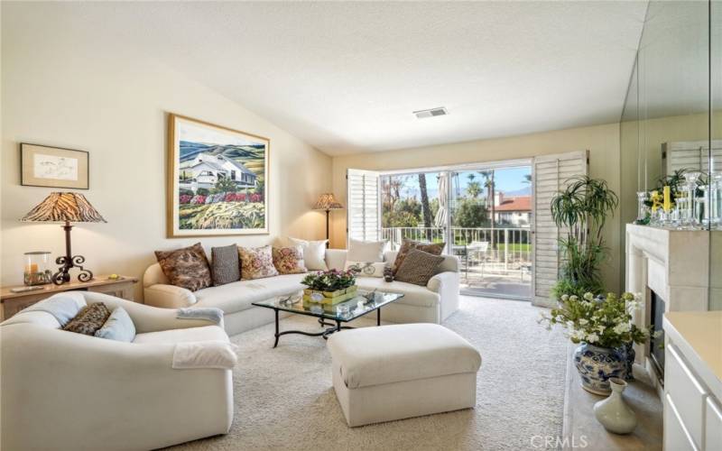 Beautiful living room with tons of natural light.  The balcony over looks the pool.