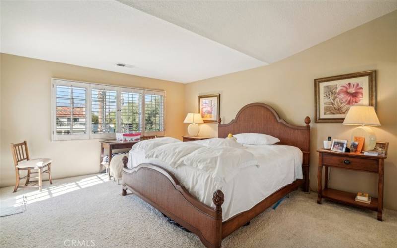 Gorgeous primary bedroom with doorway to balcony.