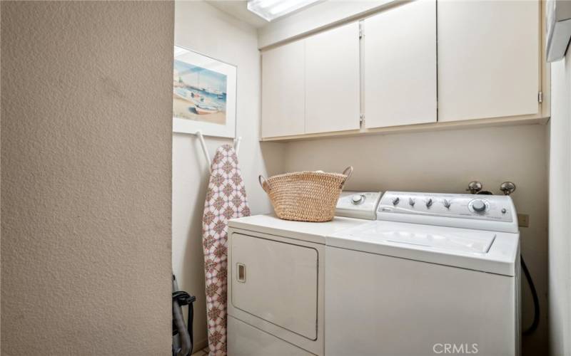 Inside laundry with storage.