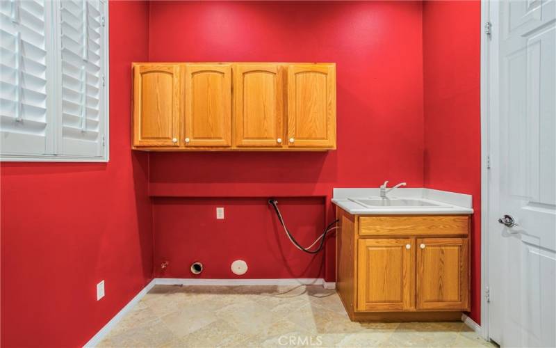 Laundry room off kitchen next to garage.