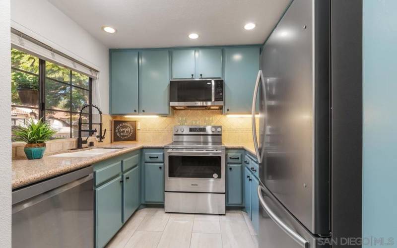 The kitchen has been elevated with brand new stainless steel appliances. You also have greenscape tree-lined views from your window.