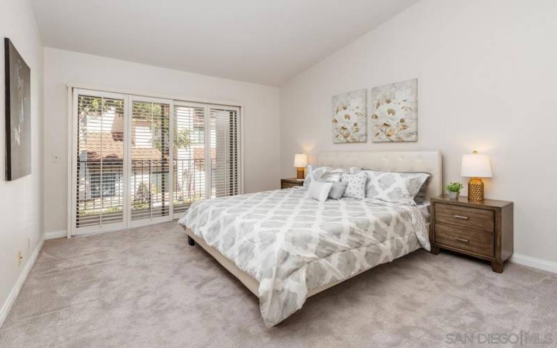 The primary bedroom has high ceilings, includes a walk-in closet and opens to a second balcony.