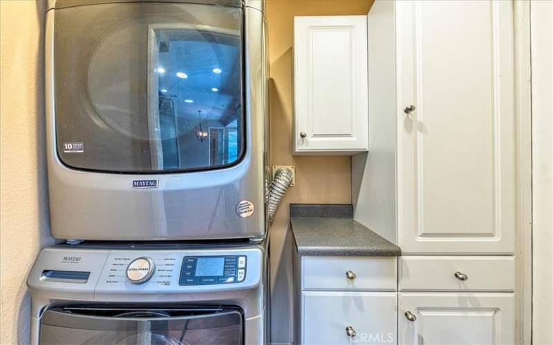 Stacked washer & dryer in laundry room