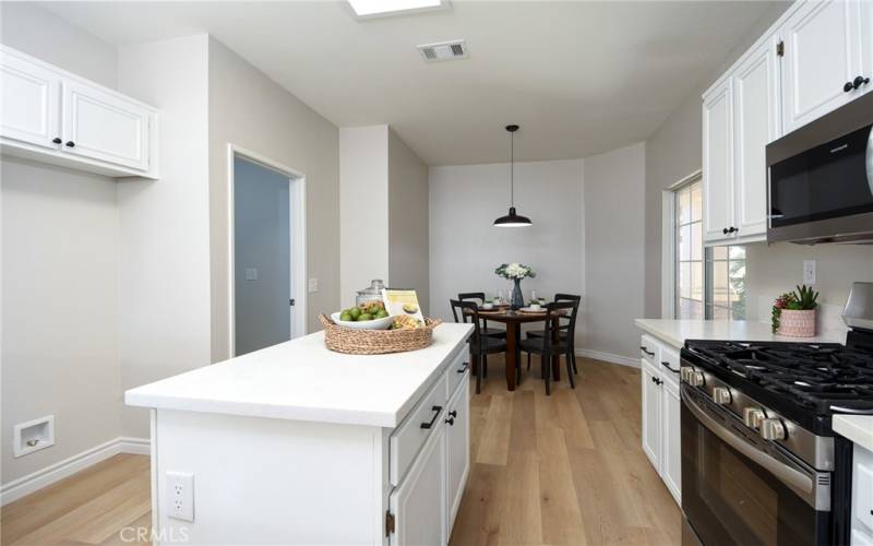 Kitchen features a center island and brand new, stainless steel appliances