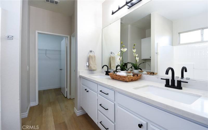 Double sink vanity with quartz countertops, new lighting and plumbing fixtures.