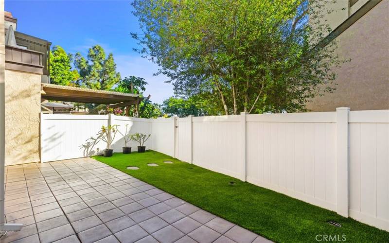 Private backyard with artificial turf.