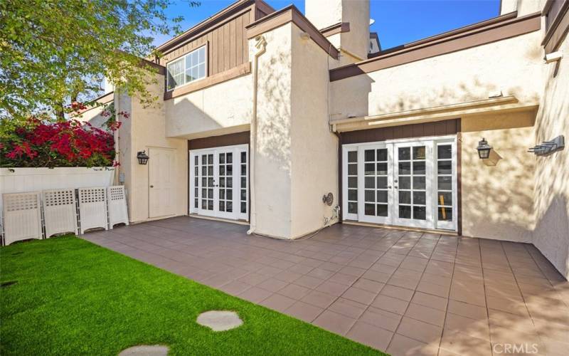 Private backyard with artificial turf.